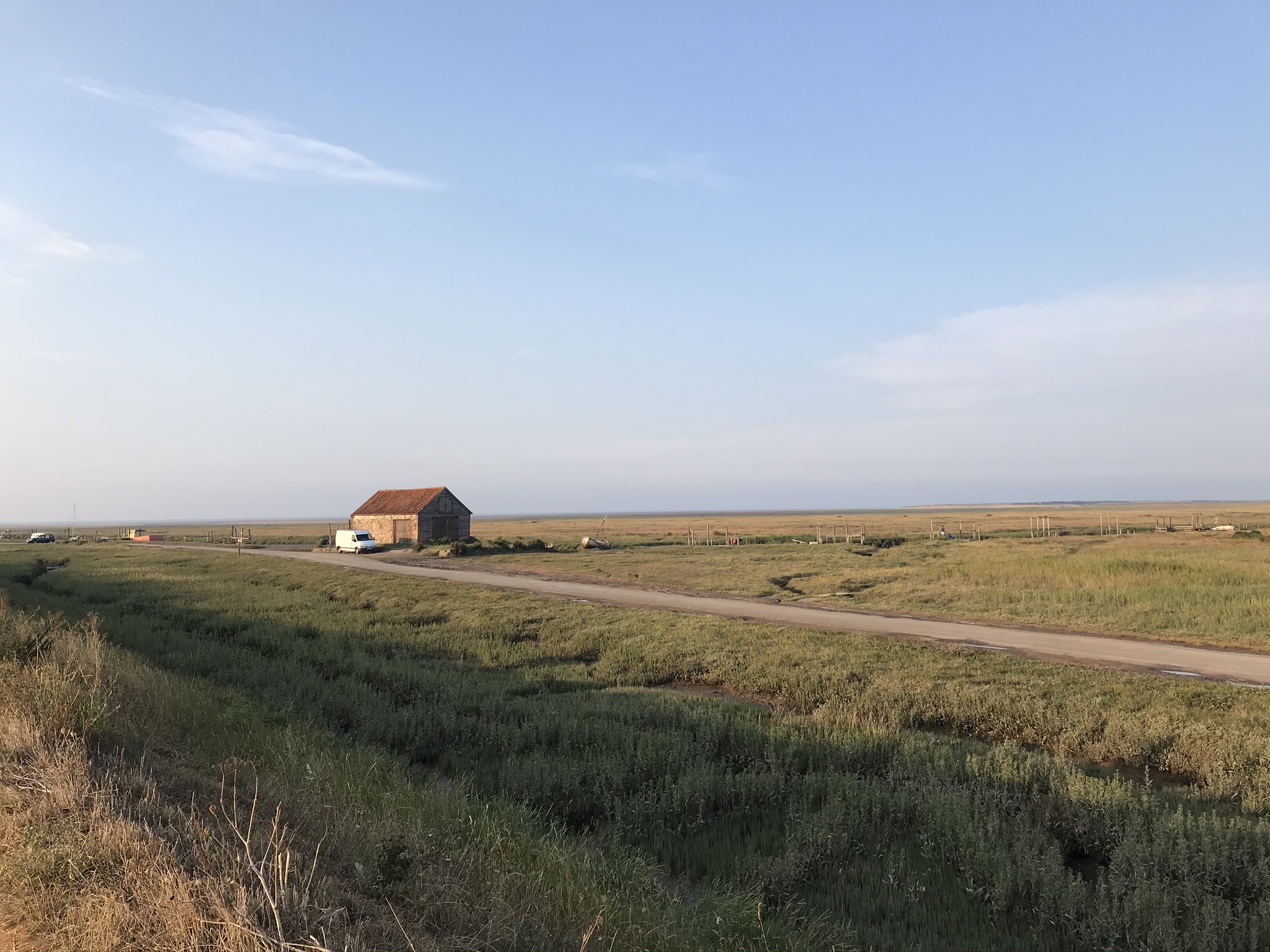 Field with small building and road